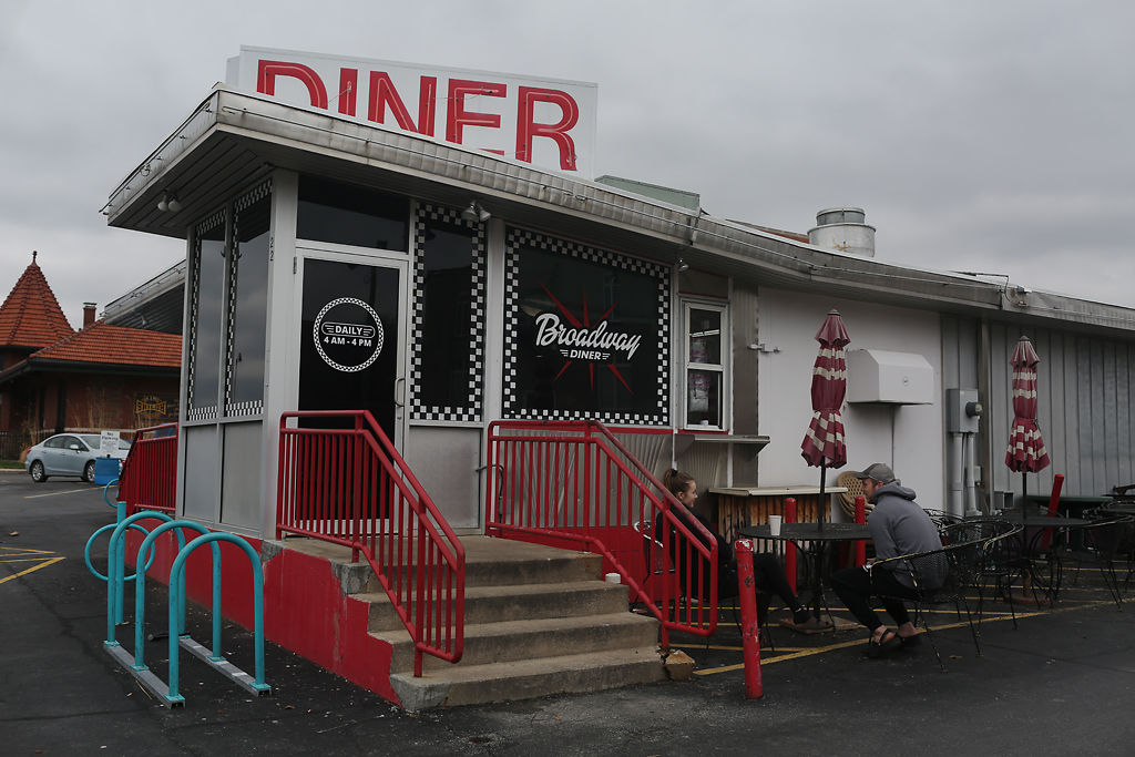 Jake Klingle and Sarah Walters sit outside the entrance to Broadway Diner